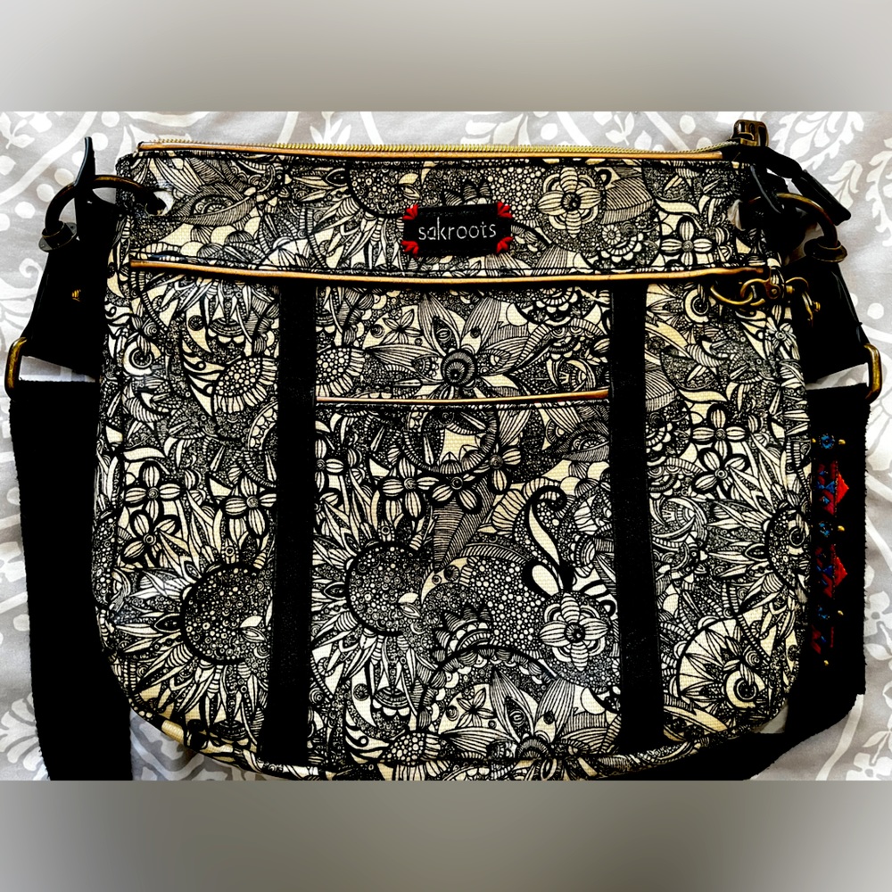 Sakroots crossbody bag, black and white with embroidered strap.